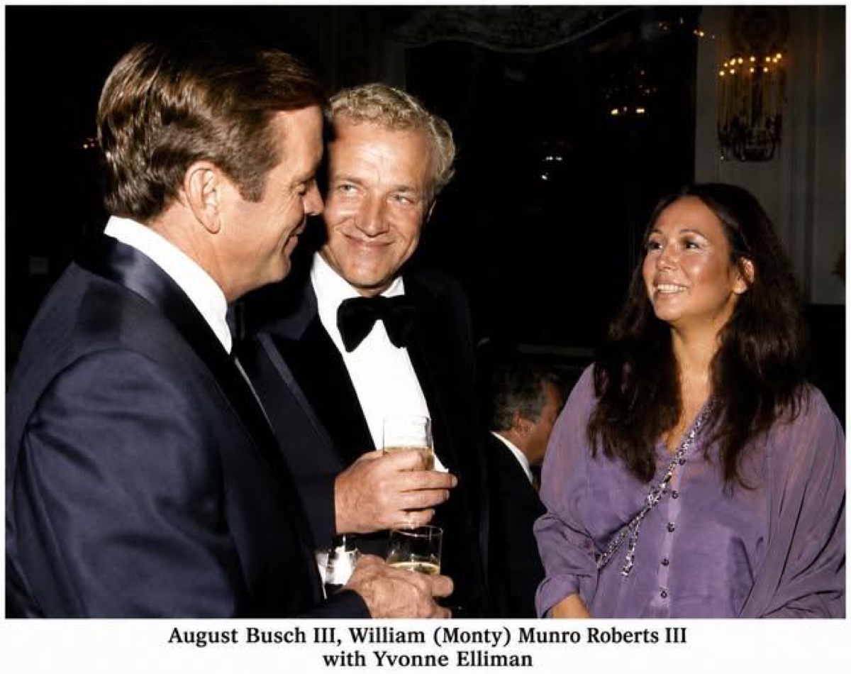 August Busch III, William (Monty) Munro Roberts III and Yvonne Elliman in conversation at a formal event